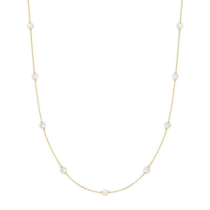 Niche Jewellery Ania Haie gold-plated chain necklace featuring spaced white shell pearls for an elegant layered look.