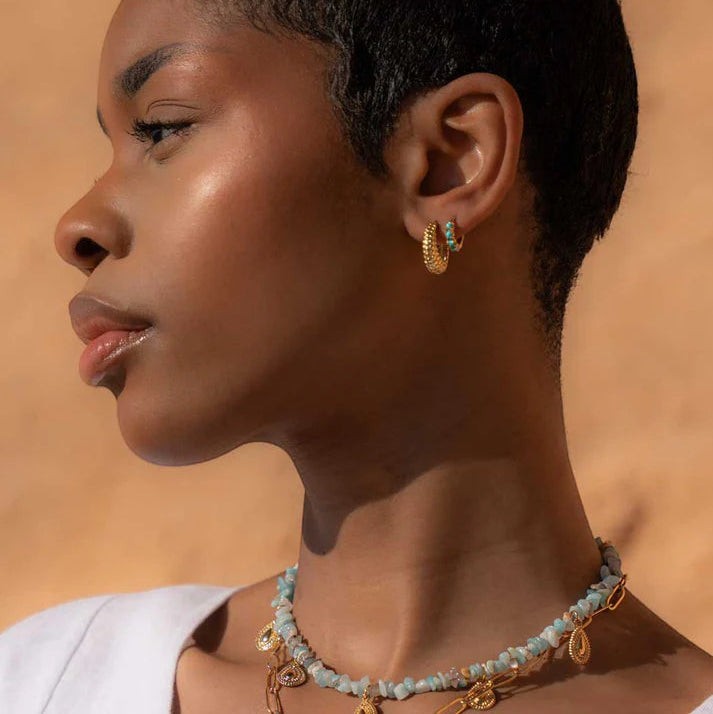 Niche Jewellery Formation Co Shore oval hoop earrings in 18k gold plated sterling silver worn by a model