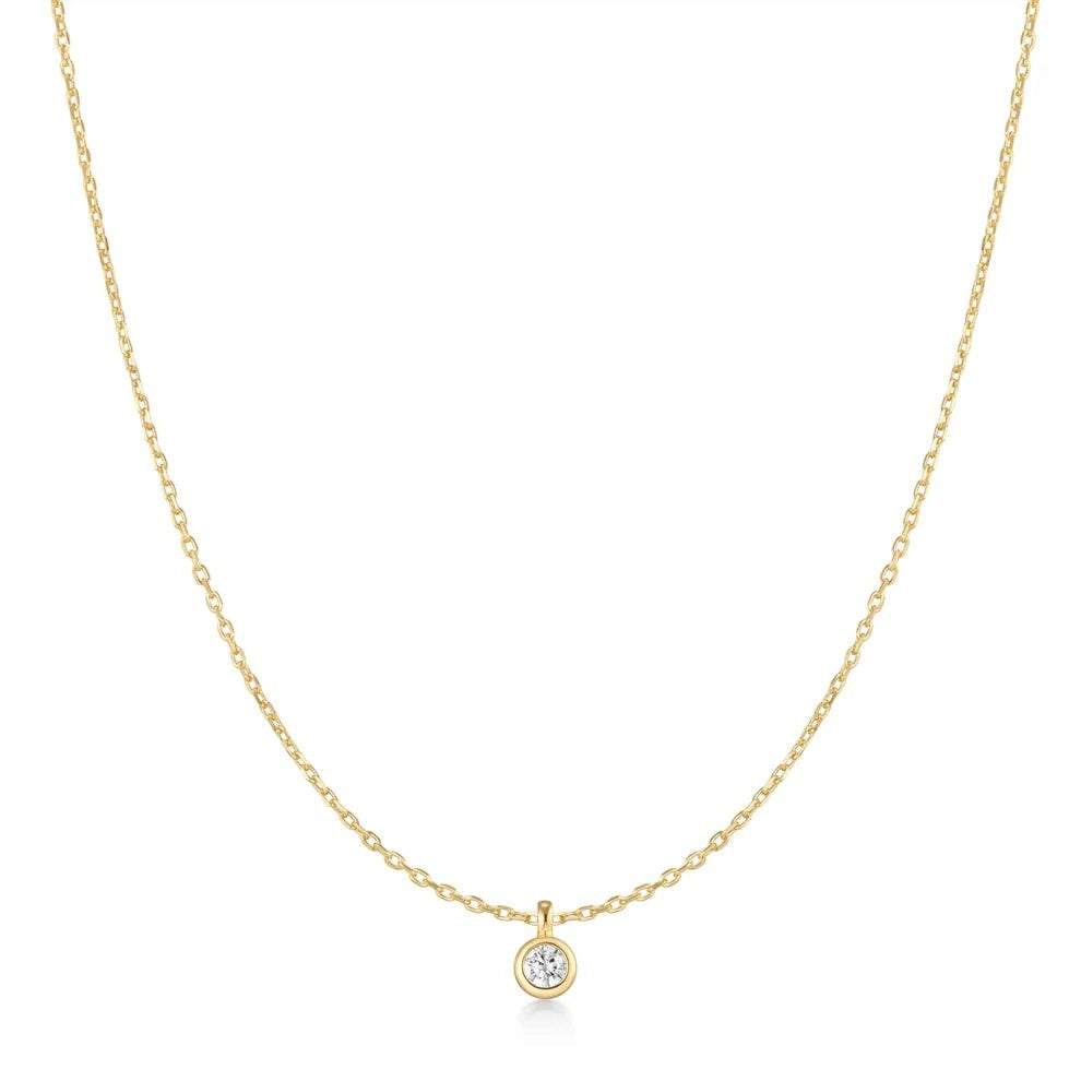 Niche Jewellery Ania Haie gold-plated necklace featuring a single bezel-set solitaire cubic zirconia pendant