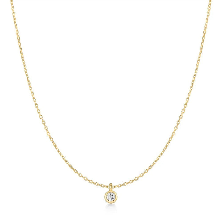 Niche Jewellery Ania Haie gold-plated necklace featuring a single bezel-set solitaire cubic zirconia pendant