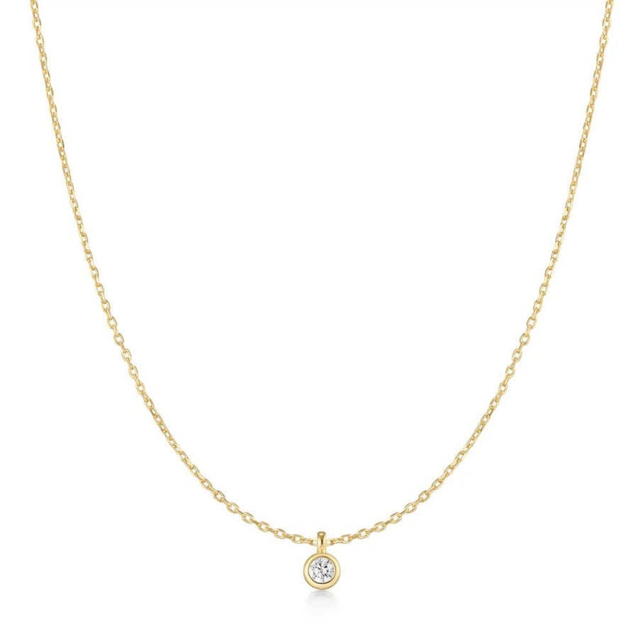 Niche Jewellery Ania Haie gold-plated necklace featuring a single bezel-set solitaire cubic zirconia pendant