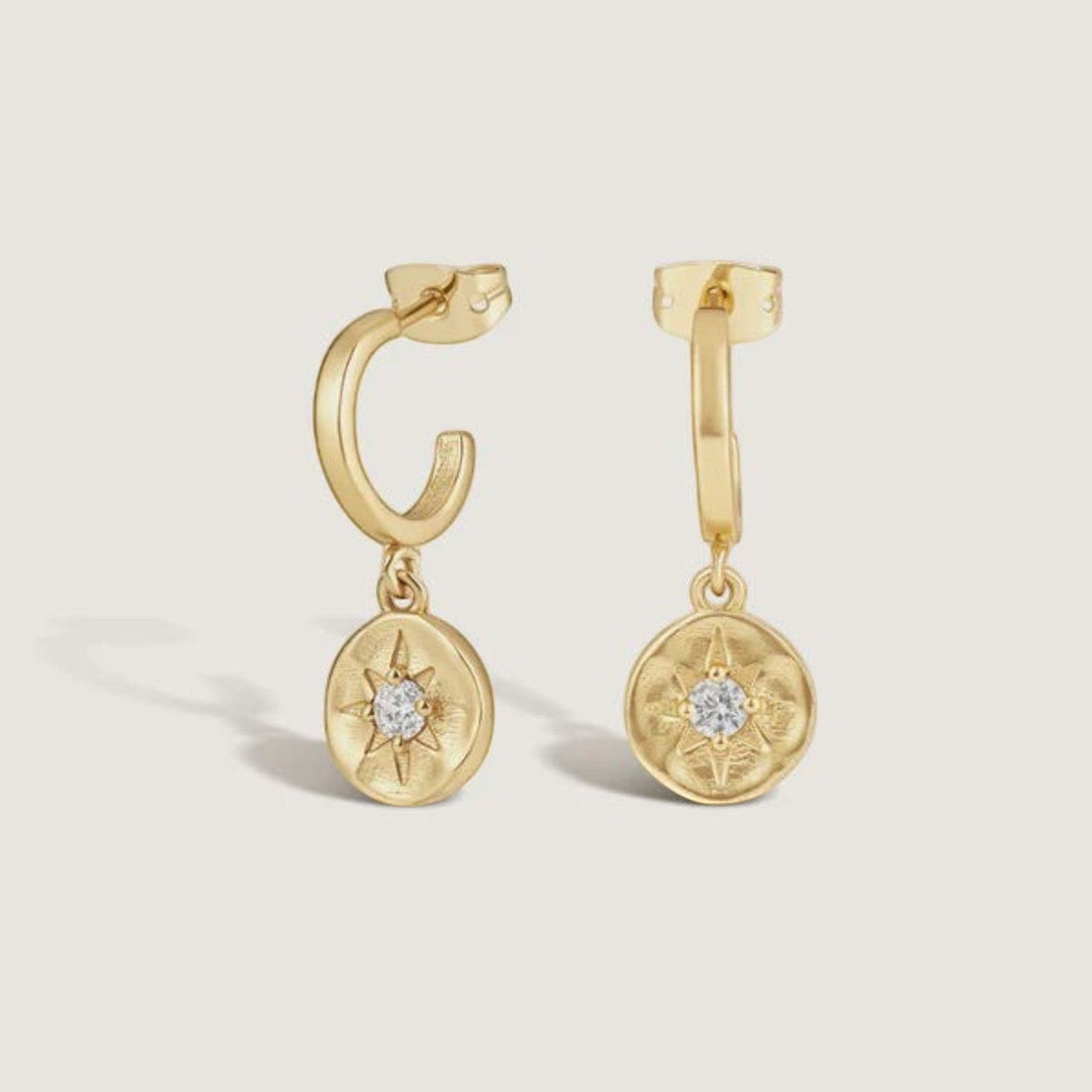 Niche Jewellery Formation Co gold plated sterling silver huggie earrings featuring a celestial star charm with a central diamante.