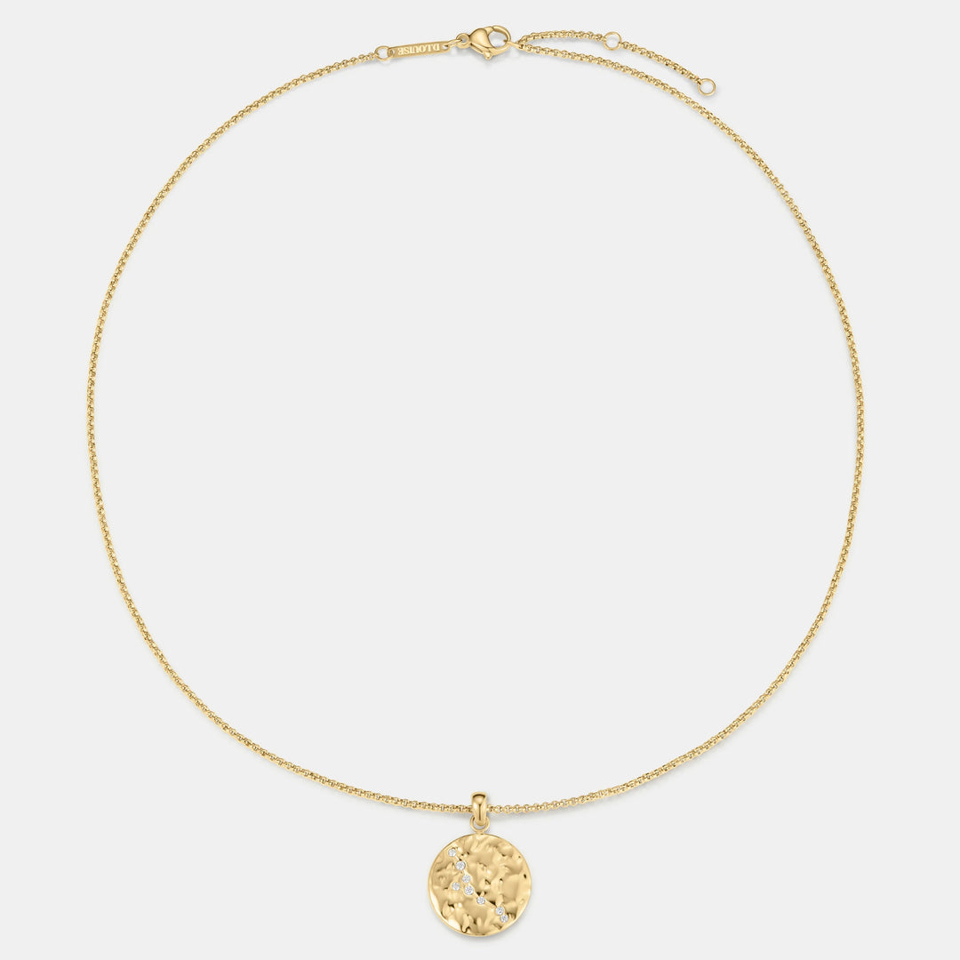 Niche Jewellery gold Taurus zodiac talisman necklace with hammered finish and small diamonds.
