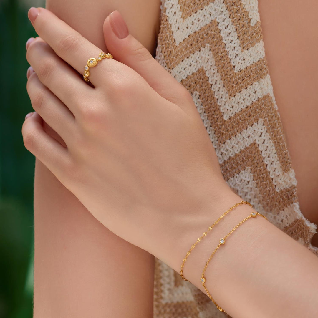 Niche Jewellery Ania Haie gold textured chain bracelet and matching ring worn on a woman's wrist and finger