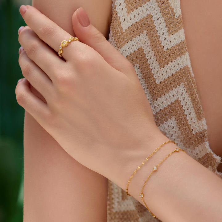 Niche Jewellery Ania Haie gold textured chain bracelet and matching ring worn on a woman's wrist and finger
