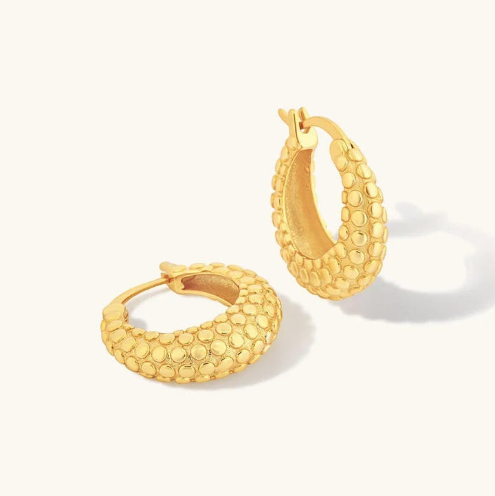 Niche Jewellery Formation Co Shore oval hoop earrings in 18k gold plated sterling silver with textured rock detail.
