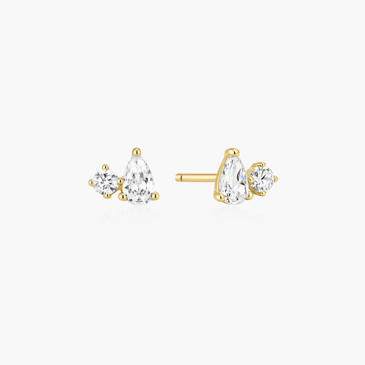 Niche Jewellery Ania Haie gold stud earrings featuring a pear-cut and round-cut cubic zirconia stone pair.