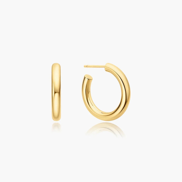 Niche Jewellery Ania Haie gold medium tube huggie hoop earrings with a smooth, minimalist design.