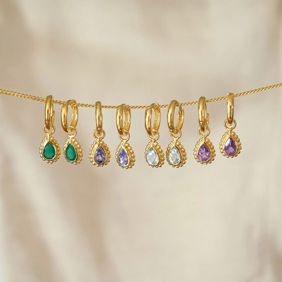 Niche Jewellery Charlotte's Web gold huggie hoop earrings featuring pear-shaped turquoise and various birthstones.