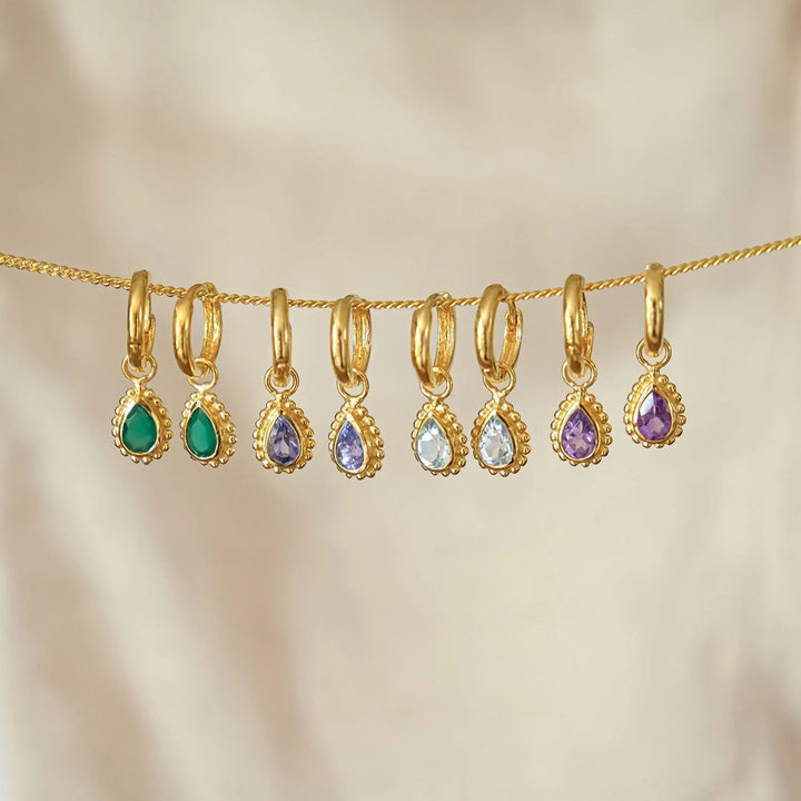 Niche Jewellery Charlotte's Web gold huggie hoop earrings featuring pear-shaped turquoise and various birthstones.