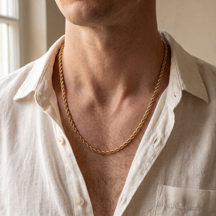 Niche Jewellery thin 18K gold plated stainless steel twisted rope chain necklace worn by a man in a white shirt