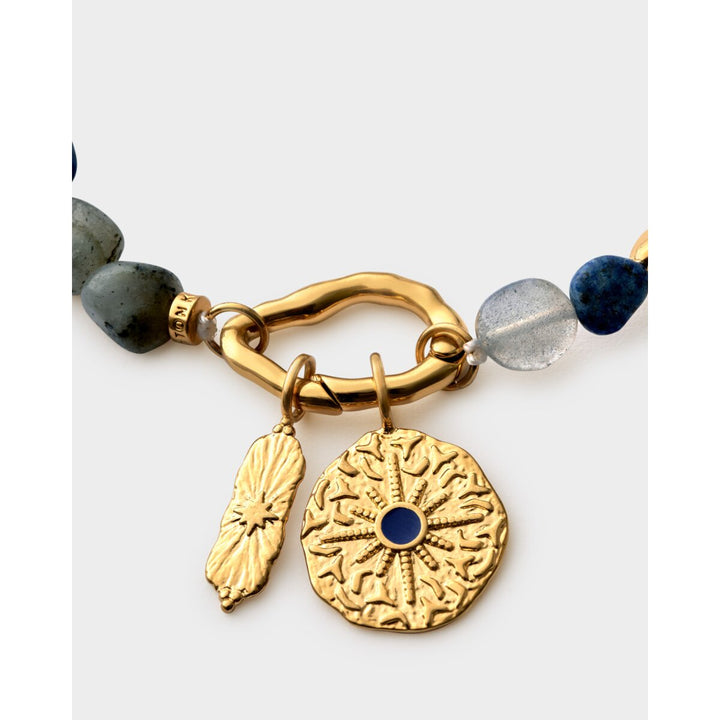 Niche Jewellery Katie Loxton gold bracelet with navy semi-precious stones and textured sunburst coin charms.