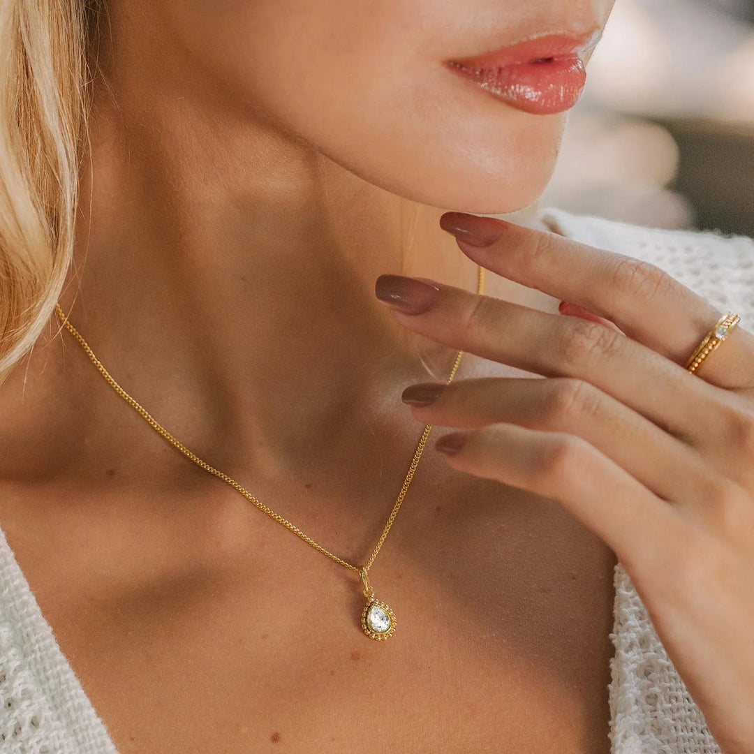 Niche Jewellery Charlotte's Web  gold necklace featuring a pear-shaped white topaz pendant on a delicate gold-plated chain.