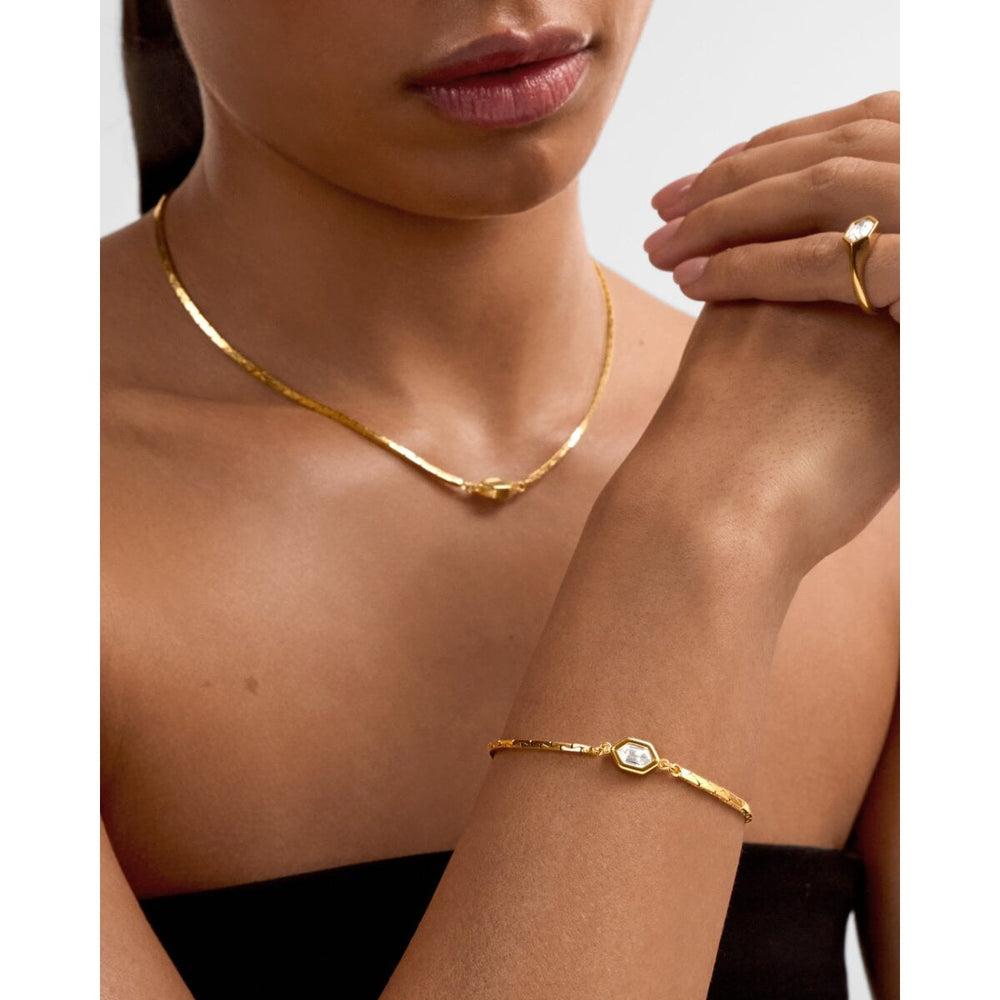 Niche Jewellery Katie Loxton Harlequin waterproof gold bracelet with diamond-check motif worn on a model's wrist