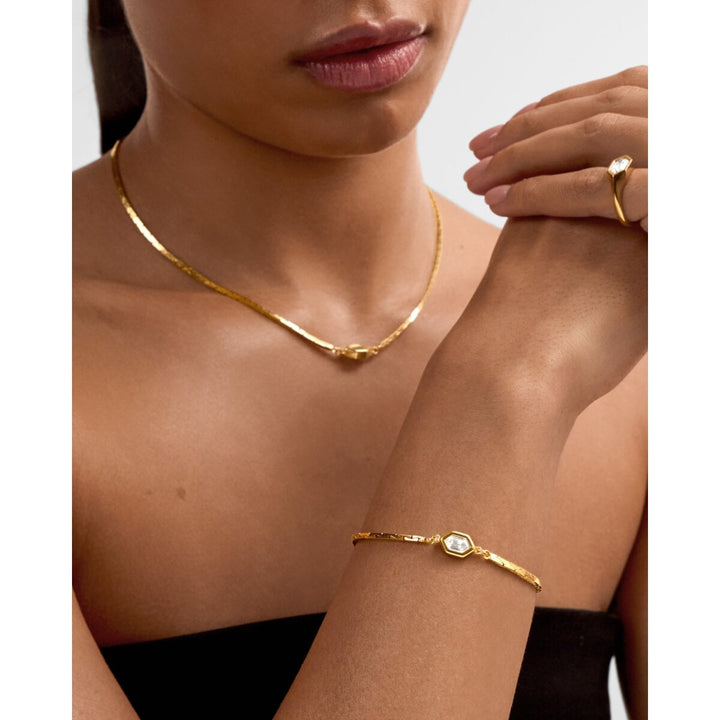 Niche Jewellery Katie Loxton Harlequin waterproof gold bracelet with diamond-check motif worn on a model's wrist