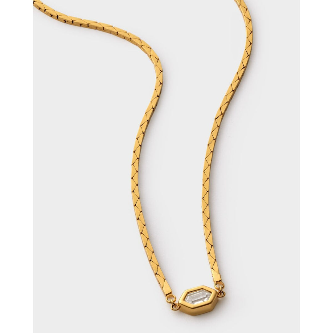 Niche Jewellery Katie Loxton Harlequin waterproof gold-tone necklace with a diamond-check pendant on a flat chain