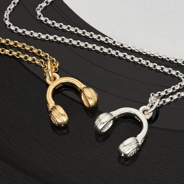 Niche Jewellery Scream Pretty gold and silver headphones pendant necklaces on a black vinyl record background