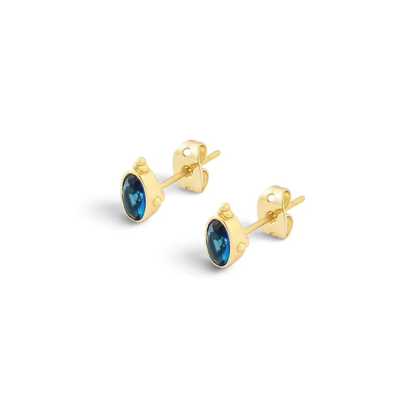 Niche Jewellery Formation Co Indus sapphire stud earrings in 18k gold plated sterling silver with a classic oval blue stone design.