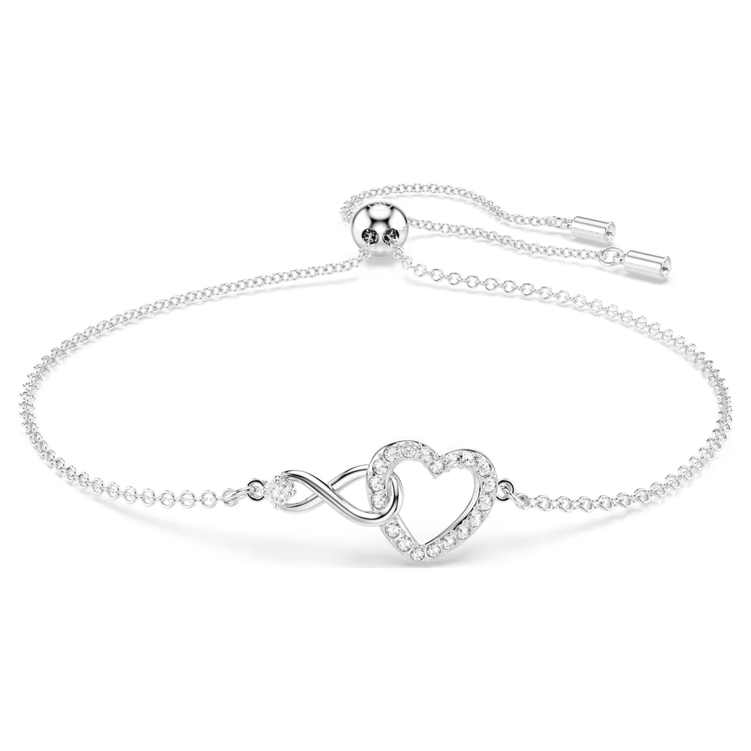 Niche Jewellery Swarovski Infinity Heart bracelet in rhodium-plated silver with sparkling white crystals.