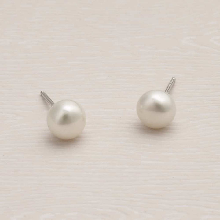 Niche Jewellery Jersey Pearl 7mm button-shaped freshwater pearl stud earrings set in sterling silver.