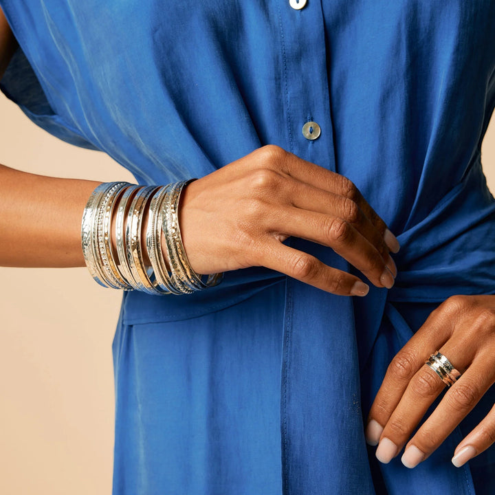 Niche Jewellery Charlotte's Web Karma Abundance spinning bangle in recycled sterling silver worn on a wrist.