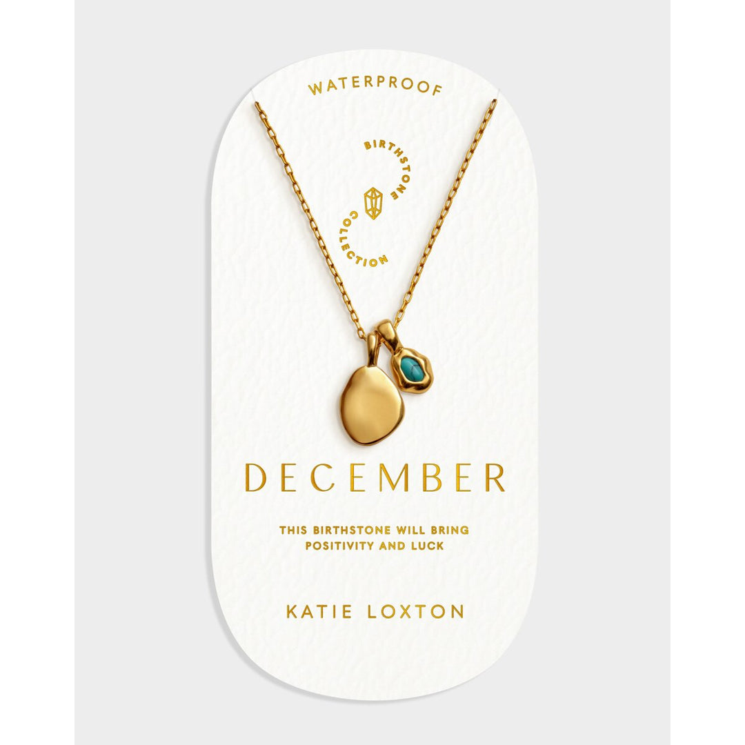 Niche Jewellery Katie Loxton December birthstone necklace with a gold pendant and blue stone on a display card.