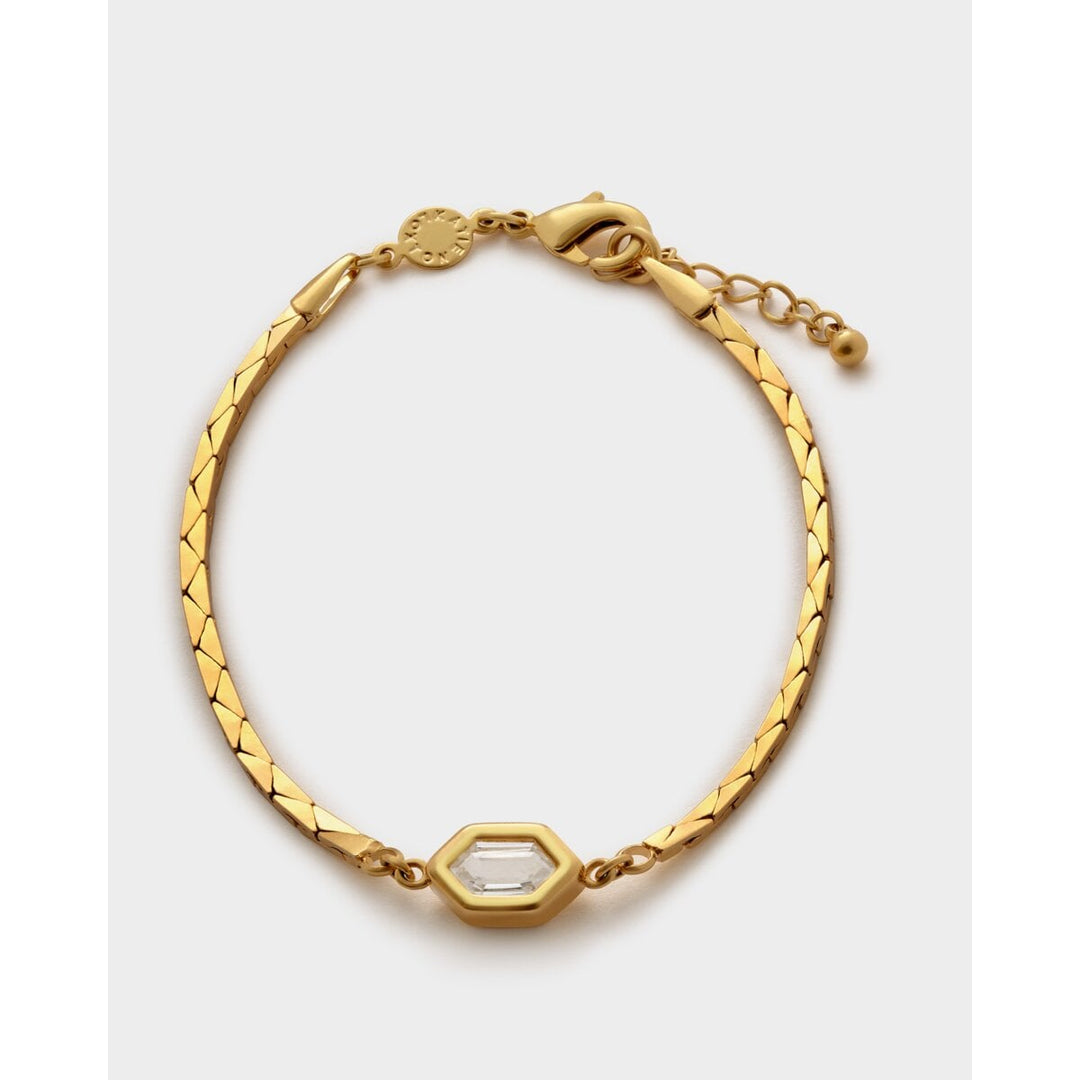 Niche Jewellery Katie Loxton gold-tone waterproof bracelet with a diamond-check pattern and a central crystal charm.