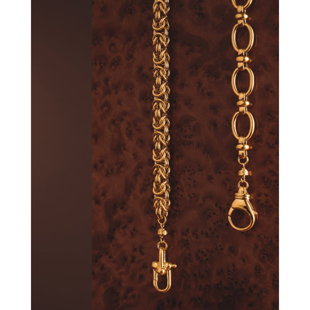 Niche Jewellery Katie Loxton Heritage waterproof gold chunky Byzantine chain bracelet on a dark wooden background.