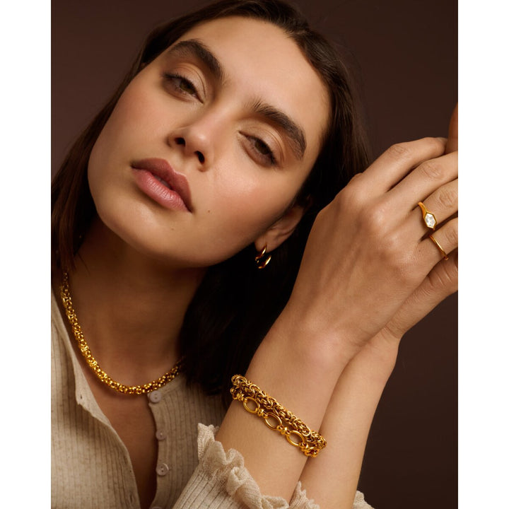 Niche Jewellery Katie Loxton Heritage waterproof gold Byzantine chain bracelet worn on a model's wrist