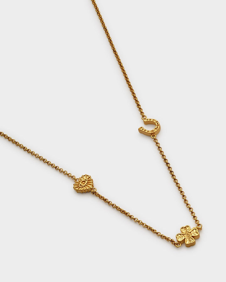Niche Jewellery Katie Loxton gold-tone waterproof necklace featuring lucky charm symbols on a delicate chain.