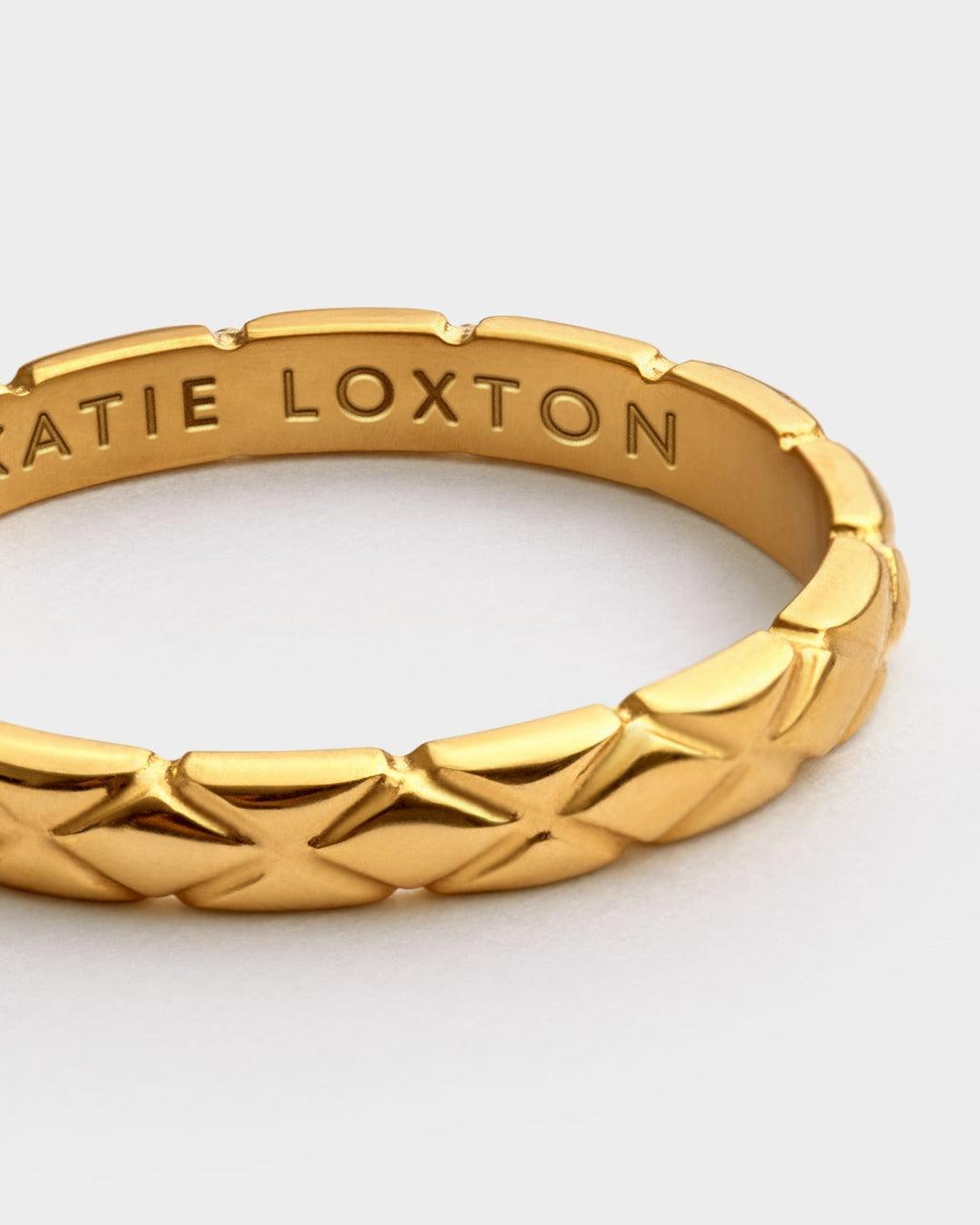 Niche Jewellery Katie Loxton gold-tone waterproof ring featuring a textured diamond-check pattern on a slim band.