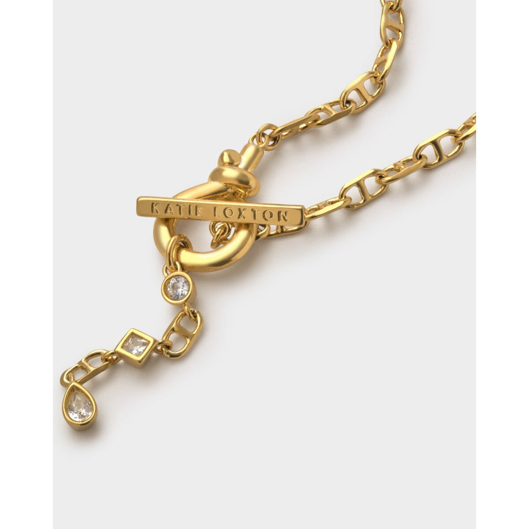 Niche Jewellery Katie Loxton gold-tone waterproof bracelet with toggle clasp and sparkling crystal charms.