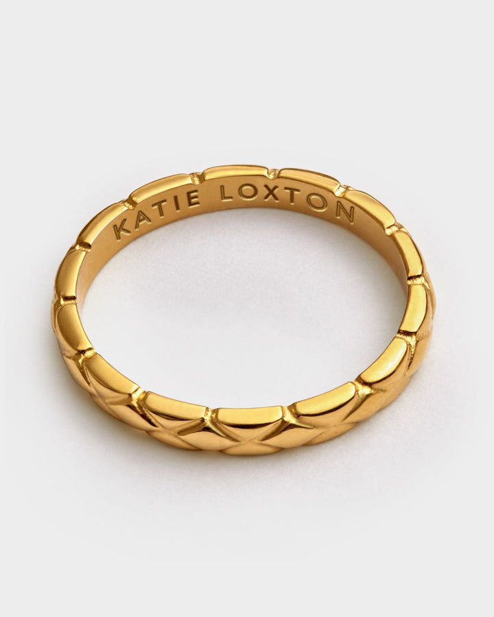 Niche Jewellery Katie Loxton gold-tone waterproof ring featuring a diamond-check pattern and engraved inner band.