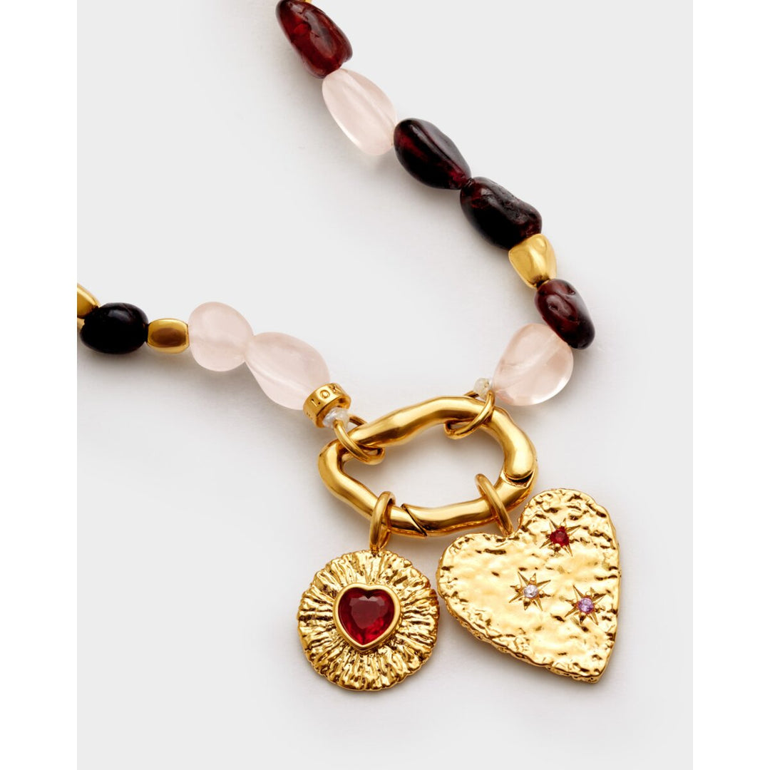 Niche Jewellery Katie Loxton Cherie bracelet featuring pink and dark red stones with gold heart and sunburst charms.