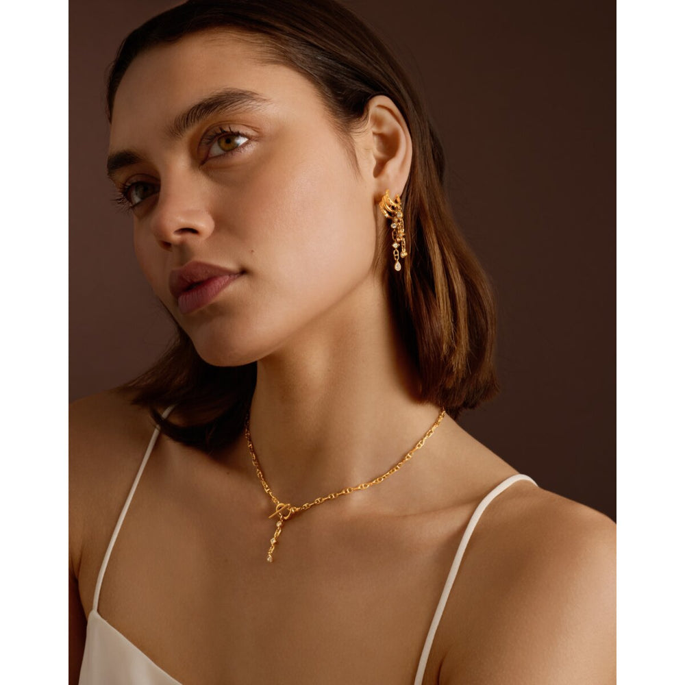 Niche Jewellery Katie Loxton waterproof gold necklace with a delicate pendant worn by a model in a white top
