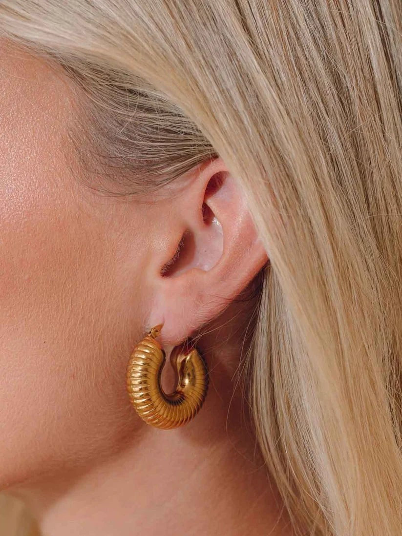Niche Jewellery Formation Co Lila sculptural gold plated sterling silver ribbed hoop earrings worn on ear