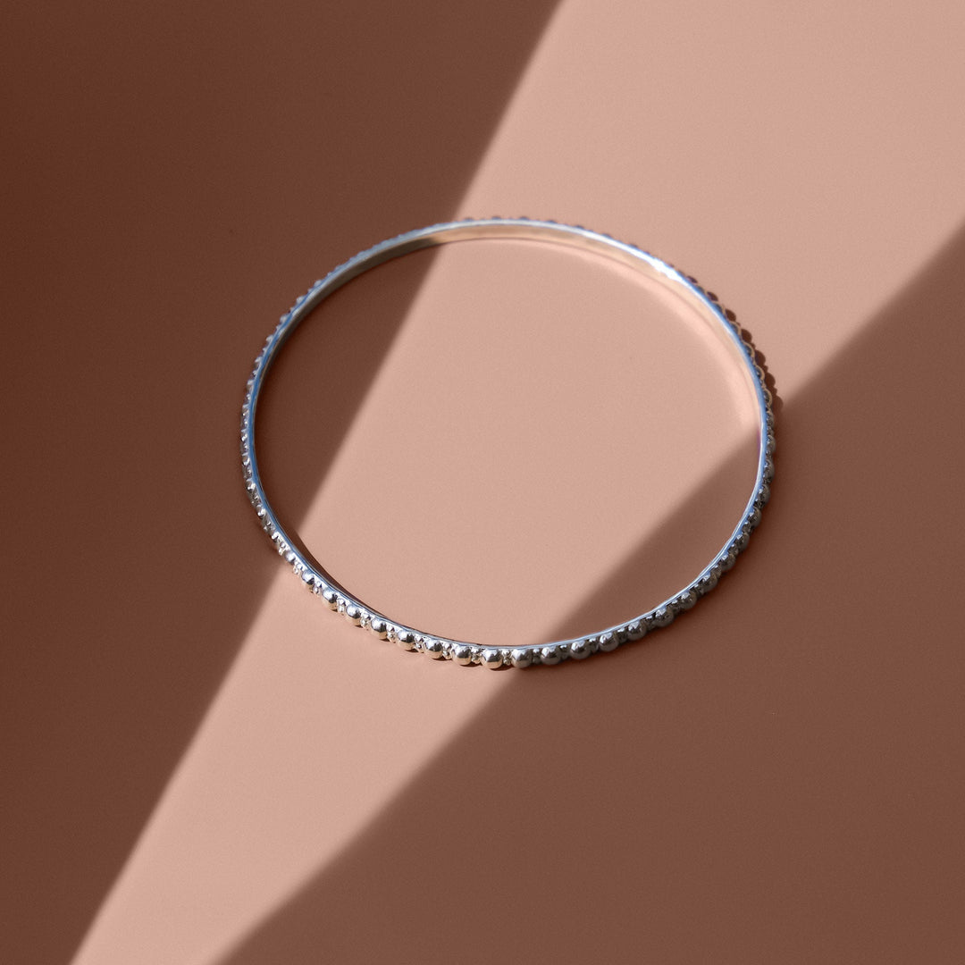 Niche Jewellery Charlotte's Web Maharani sterling silver stacking bangle with delicate bubble detailing.