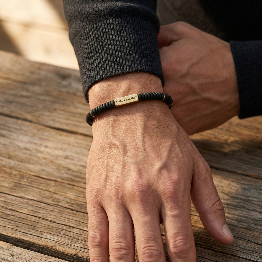 Niche Jewellery Steel & Barnett matte black onyx disc bracelet with 18K gold-plated stainless steel on a man's wrist.