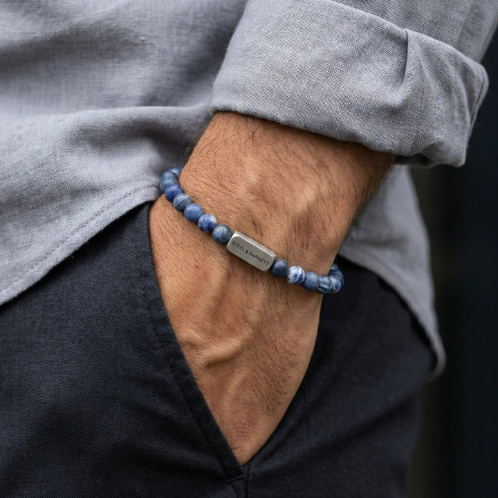Niche Jewellery Steel & Barnett matte sodalite bead bracelet with stainless steel accent on a man's wrist.