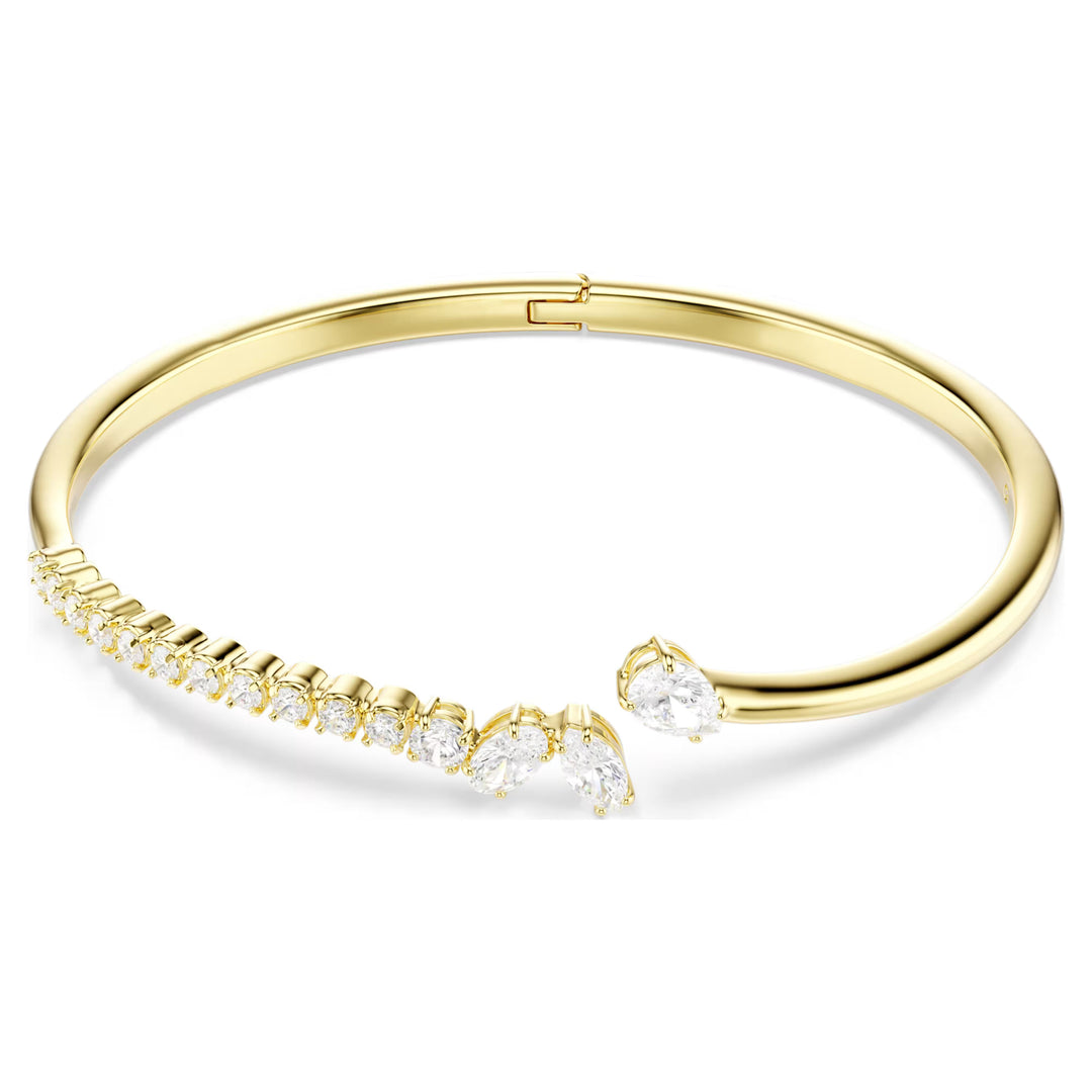 Niche Jewellery Swarovski Mesmera bangle featuring mixed cut white zirconia stones on an 18k gold plated band.