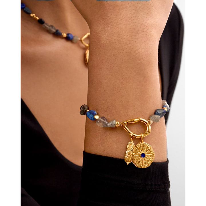 Niche Jewellery Katie Loxton Midnight Solesi waterproof gold bracelet with navy semi-precious stones on a model wrist