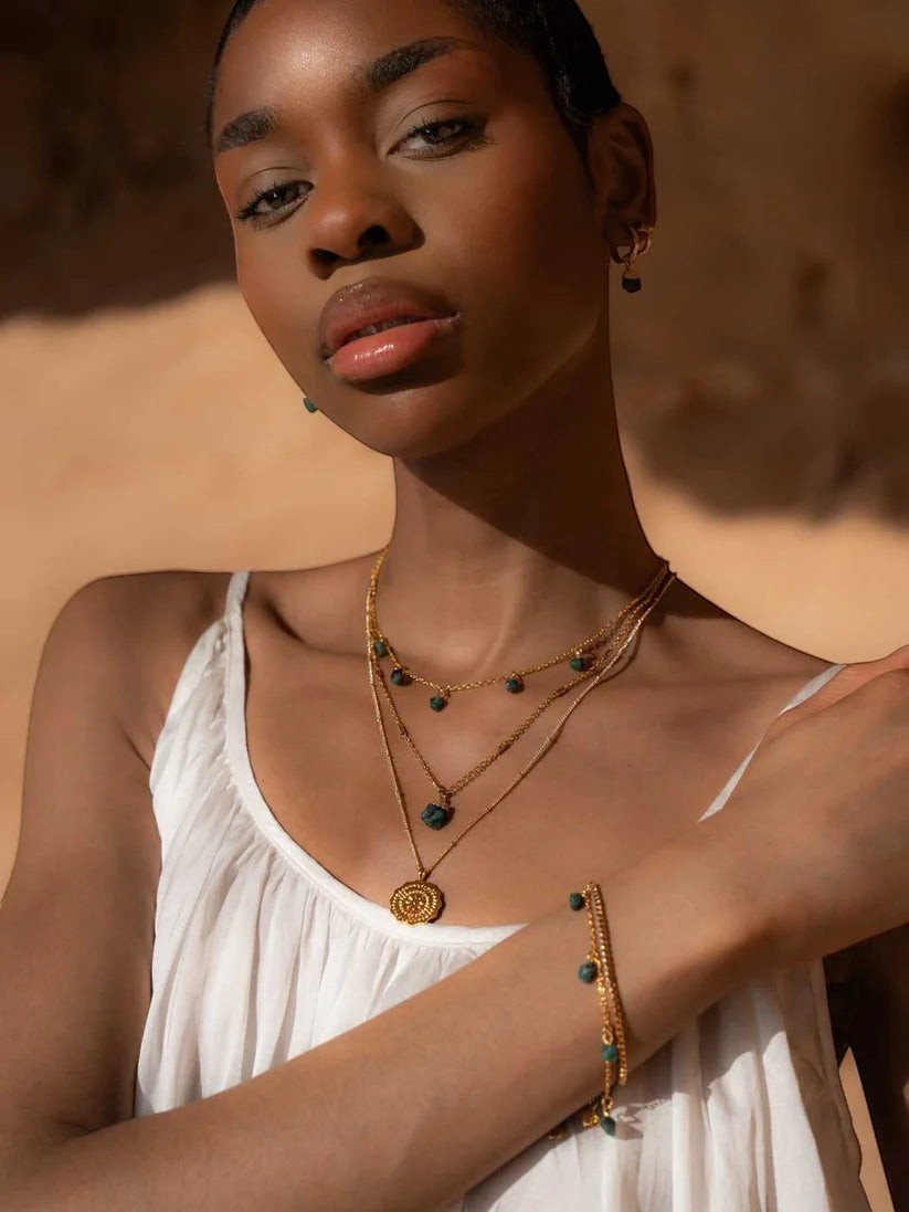 Niche Jewellery Mohica emerald necklace featuring a raw-cut green stone on an 18k gold plated delicate chain.