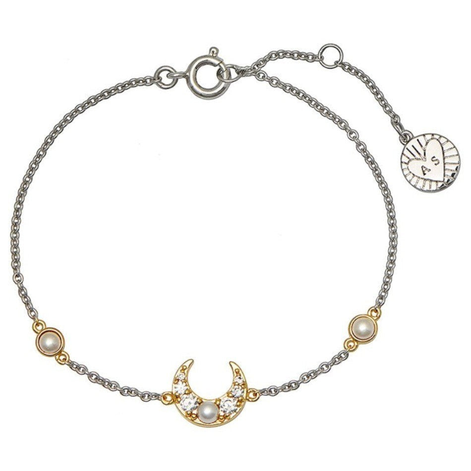 Niche Jewellery silver and gold chain bracelet with a crescent moon charm adorned with pearls and cubic zirconia.