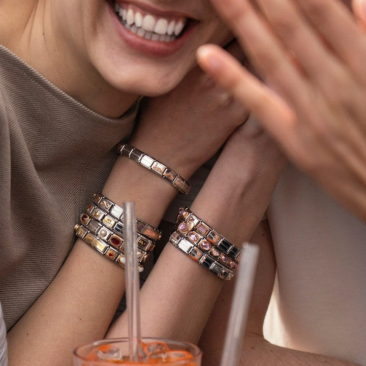 Niche Jewellery Nomination charm bracelet featuring a rose and Eiffel Tower design in stainless steel and 18k gold.
