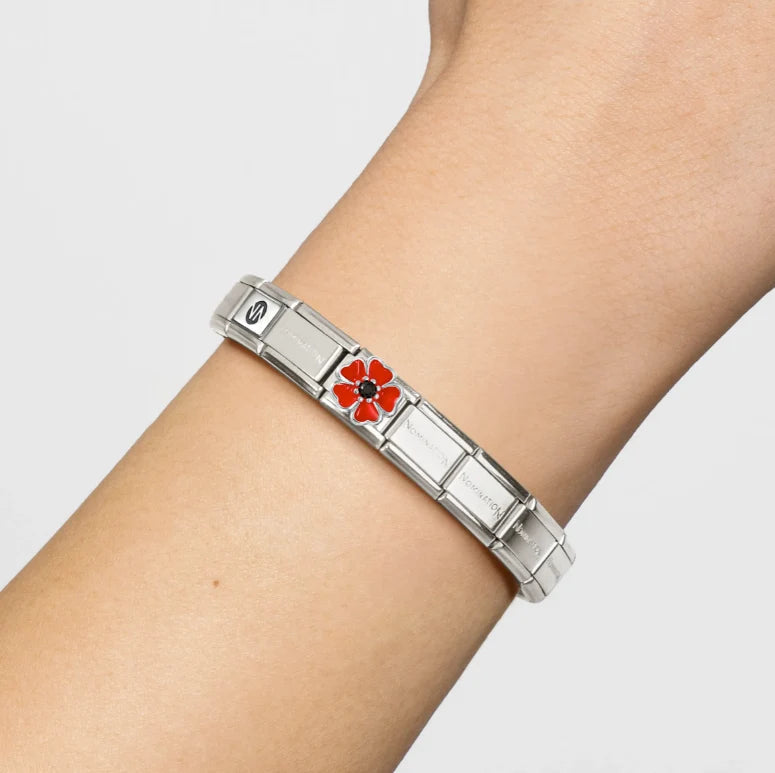 Niche Jewellery Nomination silver bracelet featuring a red and black enamel flower charm on a wrist