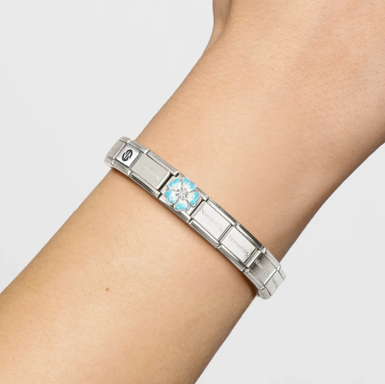 Niche Jewellery Nomination silver charm bracelet featuring a blue and white enamel flower with a zirconia centre.