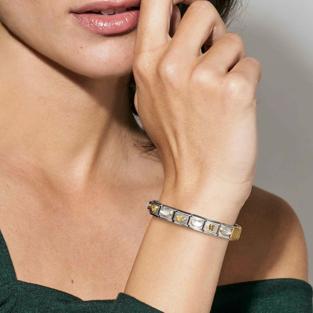 Niche Jewellery Nomination gold oval charm with green opal stone worn on a stainless steel link bracelet