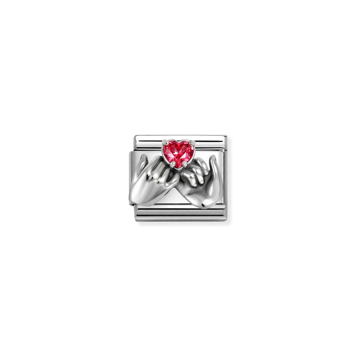 Niche Jewellery Nomination charm featuring oxidised silver hands forming a heart with a red zirconia stone