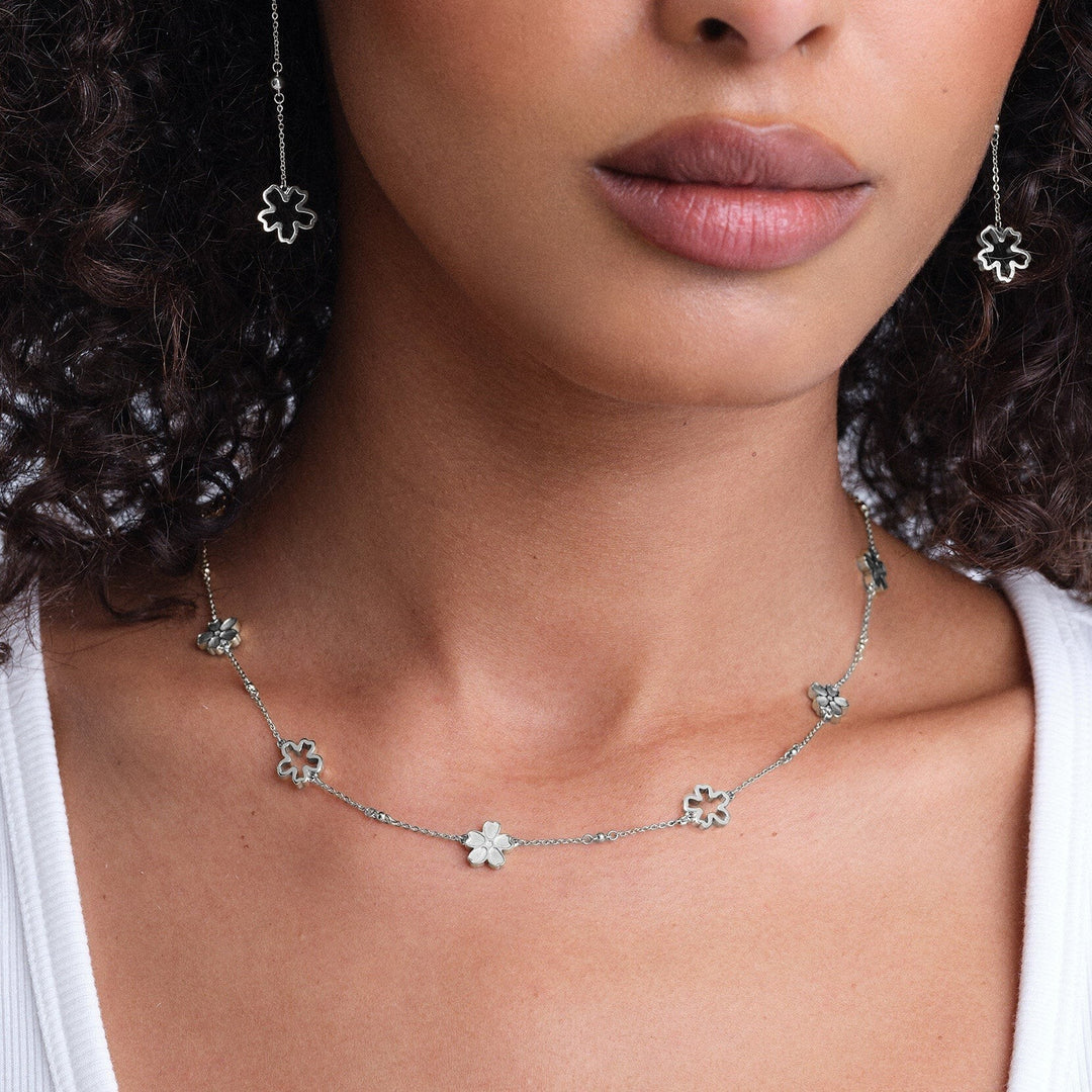 Niche Jewellery Olivia Burton silver tone necklace featuring delicate forget-me-not floral charms on a thin chain