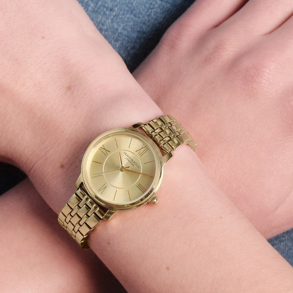 Niche Jewellery Olivia Burton Westbourne watch with a champagne dial and gold-tone bracelet on a woman's wrist